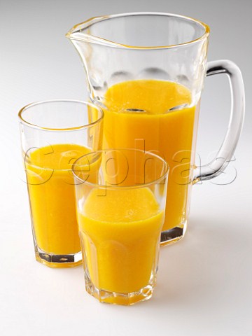 Glasses and jug of orange juice