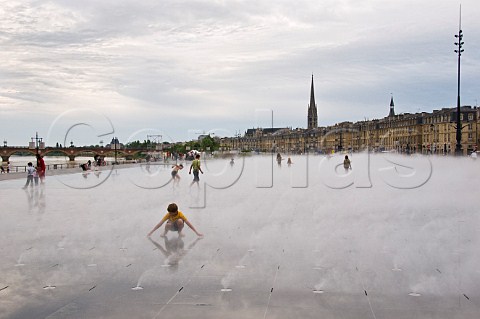 Children playing in the mist fountain at Place de la Bourse Bordeaux Gironde France