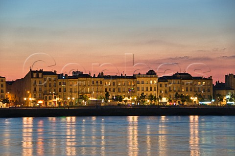 Lights of Quai des Chartrons reflecting in the Garonne river at dusk Bordeaux Gironde France