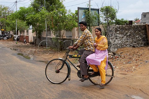 Indian man and woman on a bicycle Laxmana Nagar Kottivakkam Chennai Madras India