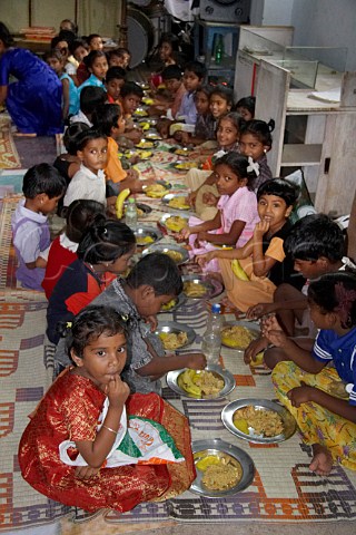 Indian children sit and eat a meal at the Compassion Ayanavaram Child Development Centre in the India Pentecostal Church of God IPC Thiruvalluvar Nagar Ayanavaram Chennai Madras India