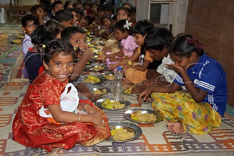 Indian children sit and eat a meal at the Compassion Ayanavaram Child Development Centre in the India Pentecostal Church of God IPC Thiruvalluvar Nagar Ayanavaram Chennai Madras India
