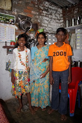 Indian family inside their brick house Thiruvalluvar Nagar Ayanavaram Chennai Madras India