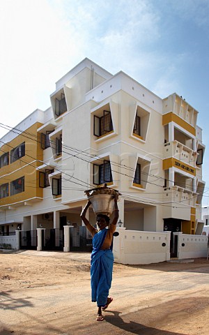Indian woman carrying container on her head Laxmana Nagar Kottivakkam Chennai Madras India