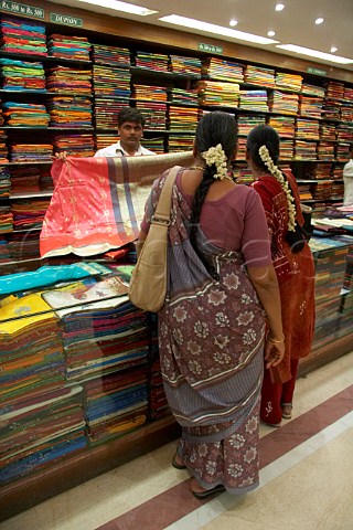 Indian women looking at sarees inside Pothys textile store Panagal Park TNagar Chennai Madras Tamil Nadu India
