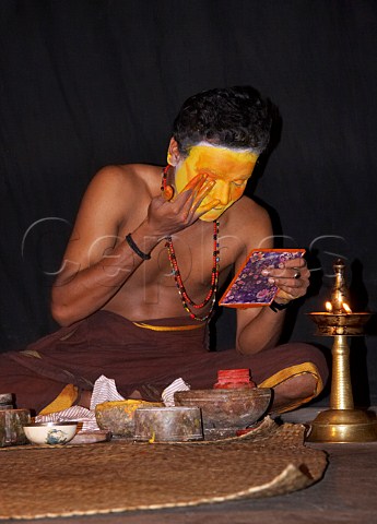 Applying makeup for the character of Lalitha before the evening performance of Narakasura Vadham at the Kerala Kathakali traditional art form of Kerala Centre Fort Cochin Kochi Cochin Kerala India