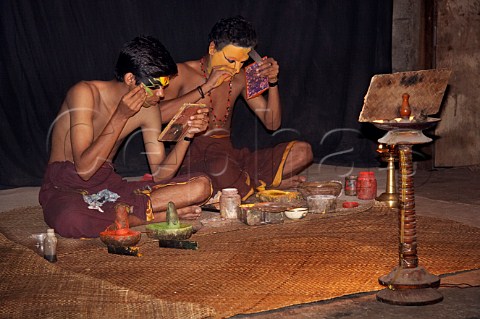 Applying makeup for the characters of Jayanthan and Lalitha before the evening performance of Narakasura Vadham at the Kerala Kathakali traditional art form of Kerala Centre Fort Cochin Kochi Cochin Kerala India