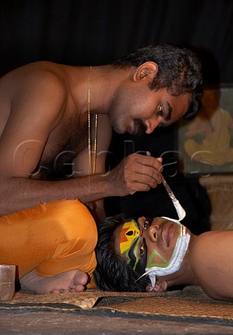 Applying makeup for the character of Jayanthan before the evening performance of Narakasura Vadham at the Kerala Kathakali traditional art form of Kerala Centre Fort Cochin Kochi Cochin Kerala India