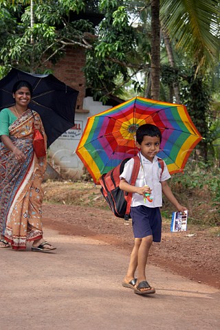 Young Indian boy and his mother walk home from school at Costa Malabari near Kannur Cannanore on the CochinMysore  CochinGoa route North Kerala India