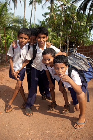 Young Indian boys on their way home from school at Costa Malabari near Kannur Cannanore on the CochinMysore  CochinGoa route North Kerala India