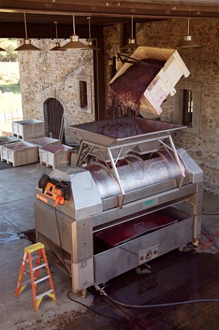 Tipping harvested grapes into the crusher in winery of Ladera Angwin Napa Valley California Howell Mountain