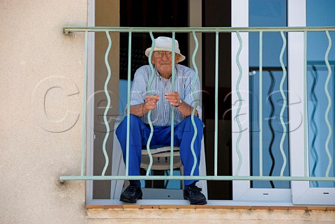 Elderly man on balcony in ChteauneufduPape Vaucluse France