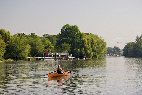 Rowing a traditional wooden skiff on the River Thames near WaltononThames