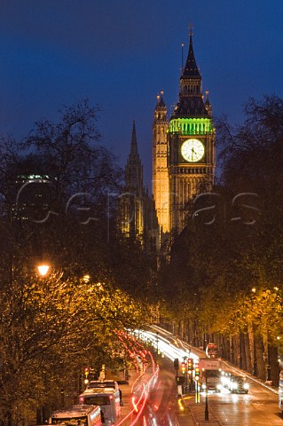 Night time traffic on the Victoria Embankment with Big Ben and the Houses of Parliament in the distance
