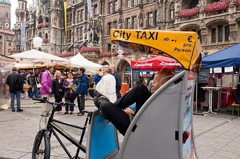 Bicycle taxi operator in the Marienplatz Munich Bavaria Germany