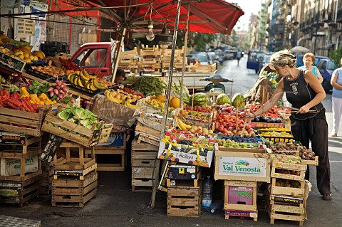 Woman setting out a stall at Mercato del Capo Palermo Sicily