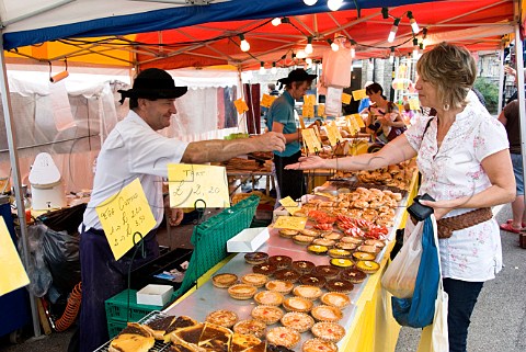 Brittany baker in traditional dress at his stall at a continental market Malton North Yorkshire England