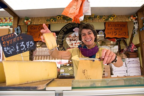 French woman selling cheese at a continental market in Malton North Yorkshire England