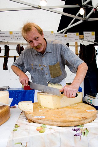 Austrian cheese seller at a continental market in Malton North Yorkshire England
