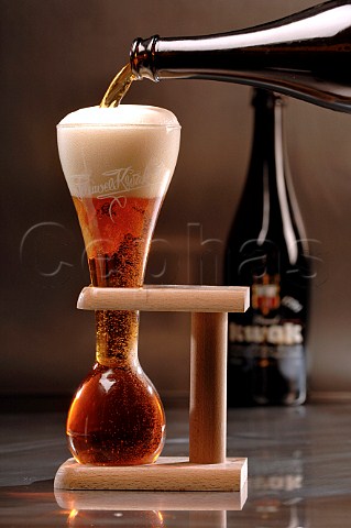 Pouring glass of Kwak Belgian beer
