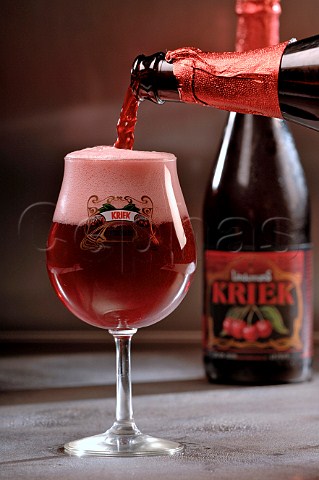 Pouring glass of Kriek Belgian fruit beer