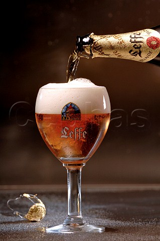 Pouring glass of Leffe blonde Belgian beer