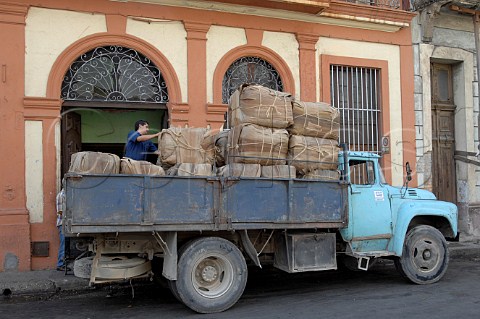 Unloading bales of tobacco for cigar production at Partagas  Havana Cuba