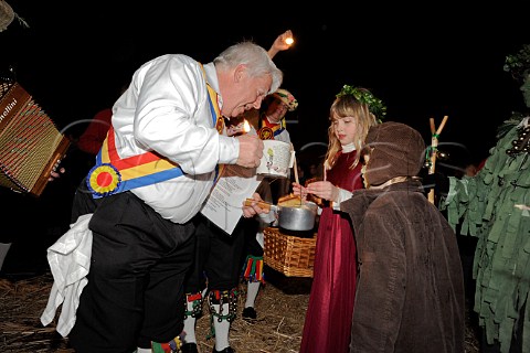 Mendip Morris Men pour cider onto toast for the Wassail Queen during Thatchers Cider Wassailing event Thatchers Cider Farm Sandford North Somerset England