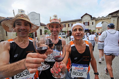 Runners drinking wine at Chteau PontetCanet refreshment station during the Marathon du Mdoc Pauillac Gironde France  Pauillac  Bordeaux