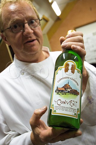 Rudi De Volder with bottle of his t Convent wine Reninge Belgium