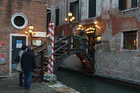 Small wooden bridge over Rio delle Beccarie canal SanPolo Venice Italy