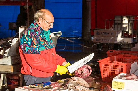 Preparing fish at the start of the days market Peschera Rialto fish market San Polo Venice Italy