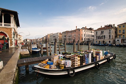 Fruit and vegetables arriving by boat on the Grand Canal for Rialto market San Polo Venice Italy