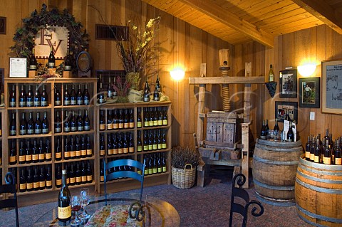 Antique wooden wine press and barrels with wine bottles inside Erath Winery tasting room  Dundee Oregon USA  Willamette Valley