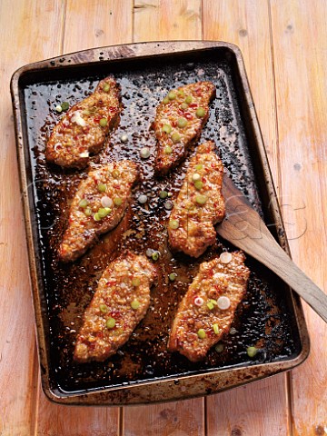 Sweet chilli baked pork loin chops in a baking tray