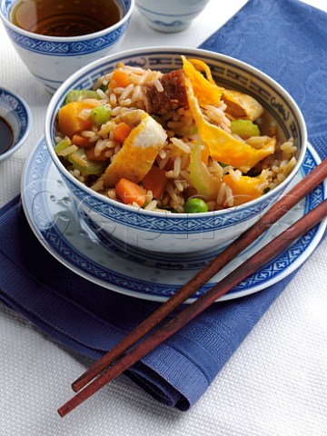 A bowl of pork fried rice with mango and Jasmine tea