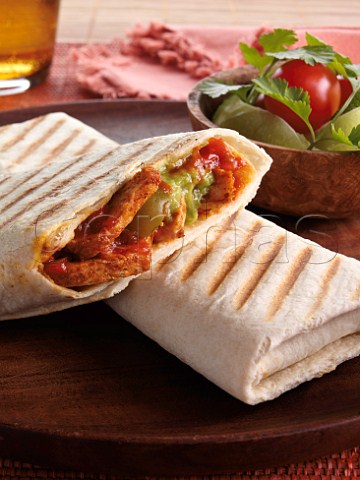 Chicken breast in a tortilla wrap with salsa and jalapeno peppers