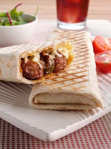 Pork meatballs in a tortilla wrap with hot chili sauce and cheese
