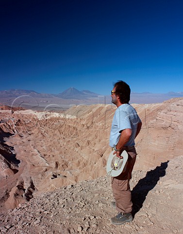 Tour guide looking out over the Valley of  Death in the Atacama Desert  Near San Pedro de Atacama Chile