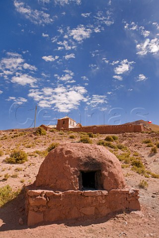 Machuca village oven with church beyond  at over 4000 metres altitude in the Atacama Desert Chile