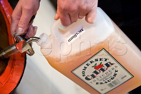 Filling a plastic container with Cider at Thatchers Cider Thatchers Cider Farm Sandford North Somerset England