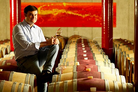 Krutzler Winery Reinhold Krutzler sitting on barrels and tasting red wine DeutschSchtzen Austria Sdburgenland