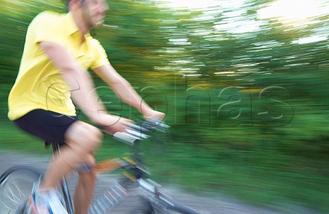 Man cycling on country road