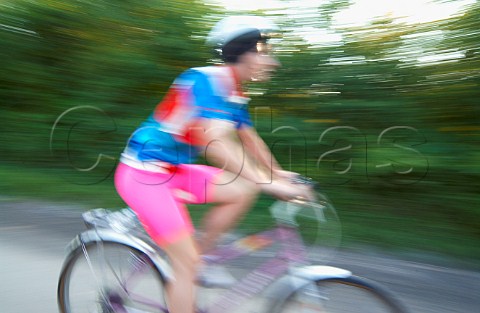 Woman cycling on country road