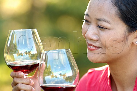 Couple drinking red wine in a vineyard