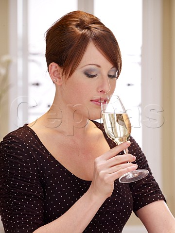 Young woman drinking glass of Champagne
