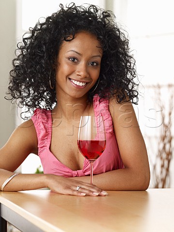 Young woman drinking glass of ros wine