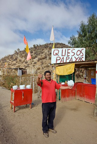 Man selling crayfish papayas and cheese at roadside stall   La Serena Chile