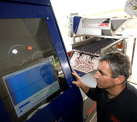 Alain Dourthe checking the settings for grape selection on the optical sorter Chteau Faugres StEtiennedeLisse near Saintmilion Gironde France  Stmilion  Bordeaux