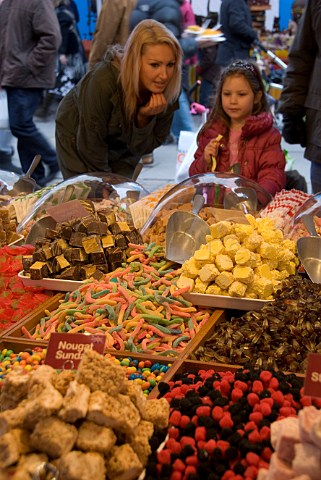 Mother and daughter choosing sweets on a German confectionery stall at the York International Market Place York England